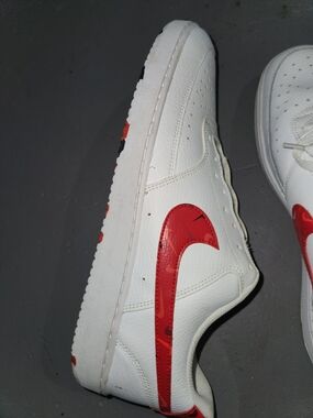 Nike Men's White Leather Athletic Sneaker with Red Swoosh